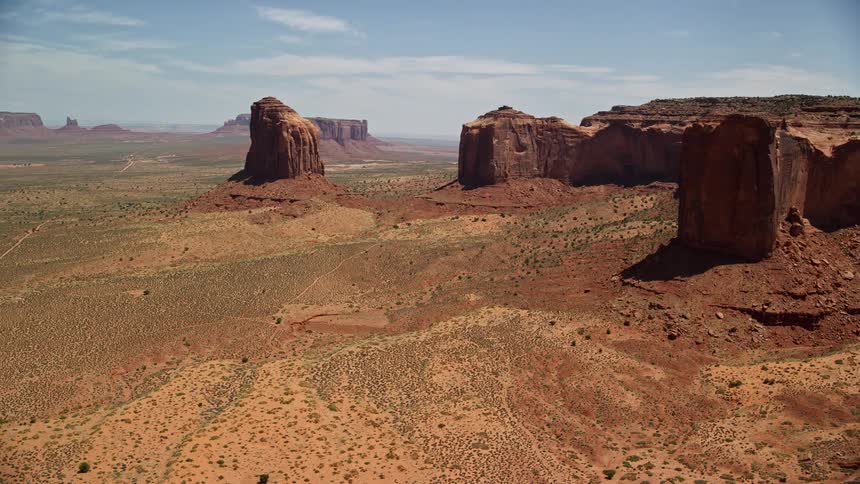  aerial footage of flying by Gray Whiskers Butte in Monument Valley Utah showcasing the stunning desert landscape tribal lands and famous natural landmarks of the Southwest United States