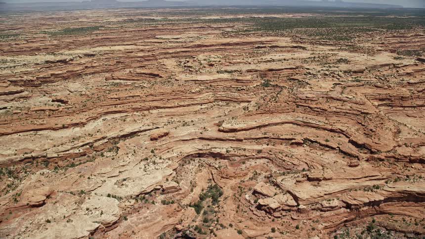 an aerial view of the desert landscape featuring mesas canyons and abundant sunshine in Cedar Mesa Utah