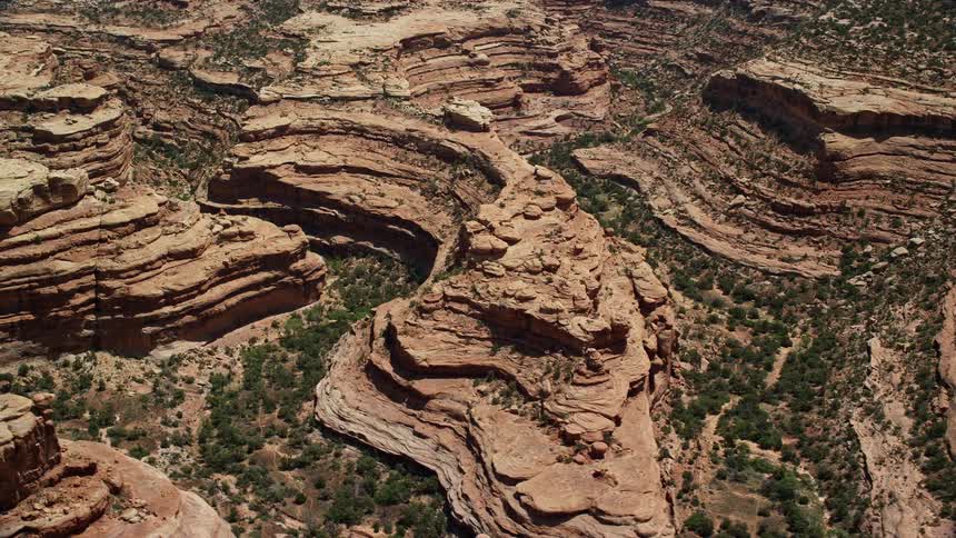 an aerial perspective of desert mesas and canyons showcasing the stunning rock formations and cliffs of Cedar Mesa Utah