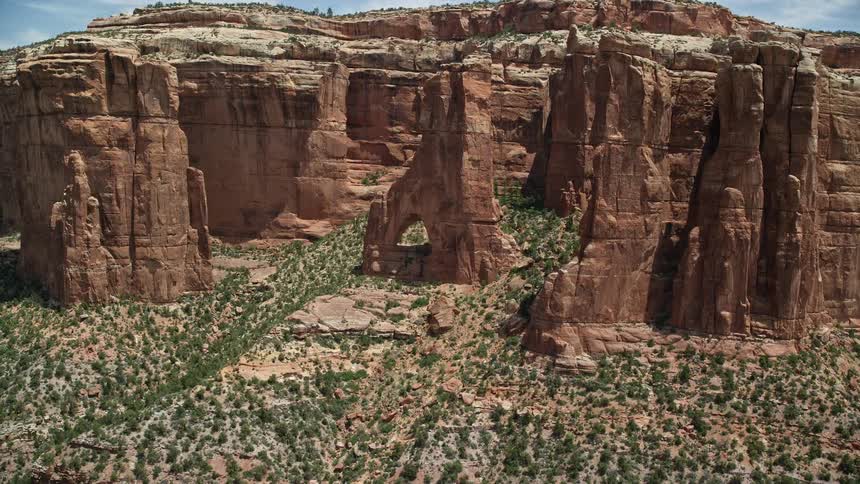 Aerial footage of Cathedral Arch in Arch Canyon Utah showcasing stunning rock formations sunny weather and a captivating orbiting shot
