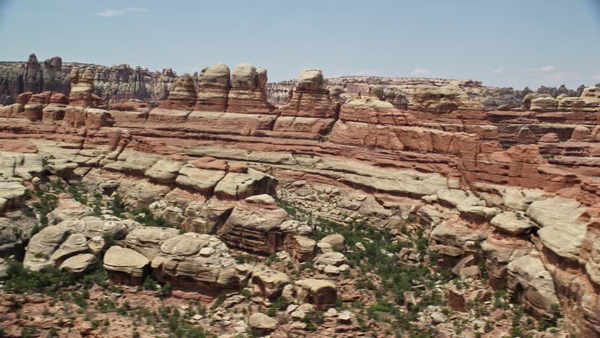 Flying over the breathtaking canyons and rock formations of Canyonlands National Park in Utah experiencing the arid beauty of the Southwest United States during a sunny day