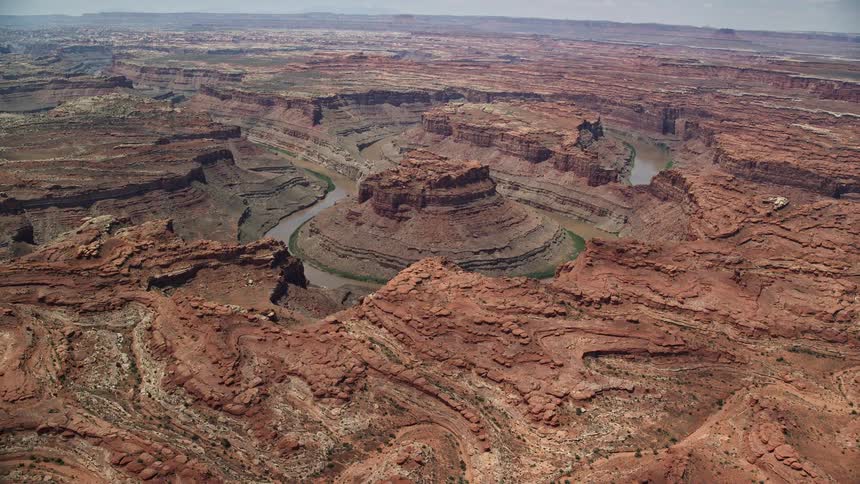  aerial footage capturing an approach and flyby through Meander Canyon showcasing the stunning Colorado River and breathtaking desert landscape of Canyonlands National Park in Utah