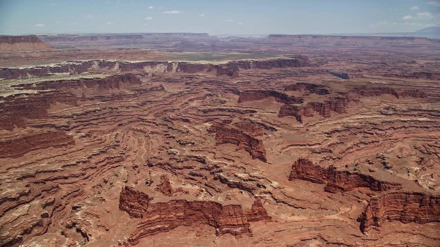 Approaching buttes and canyons near White Rim cliffs Canyonlands National Park Utah in stunning aerial footage