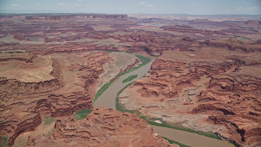 Aerial view of the Colorado River winding through the arid landscapes of Meander Canyon in Canyonlands National Park Utah