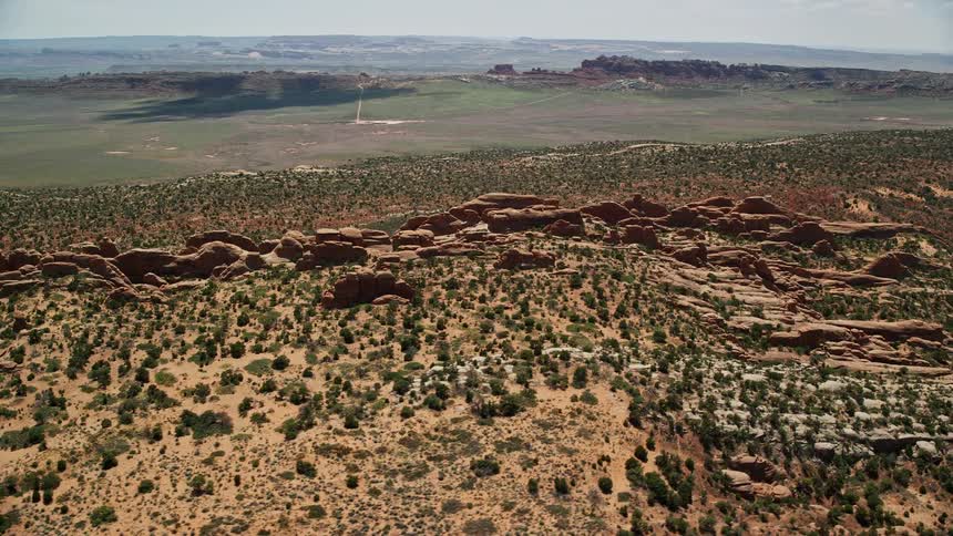 Aerial footage of the iconic red rock fins in Devil's Garden Arches National Park Utah showcasing the stunning desert landscape and natural rock formations