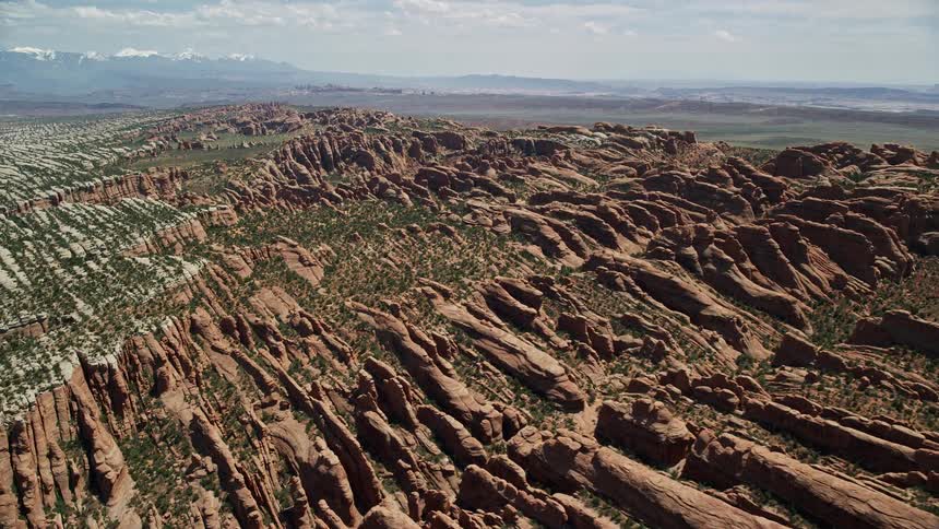 Aerial footage of the iconic red rock fins at Devil's Garden in Arches National Park Utah showcasing the stunning desert landscape during daytime in summer