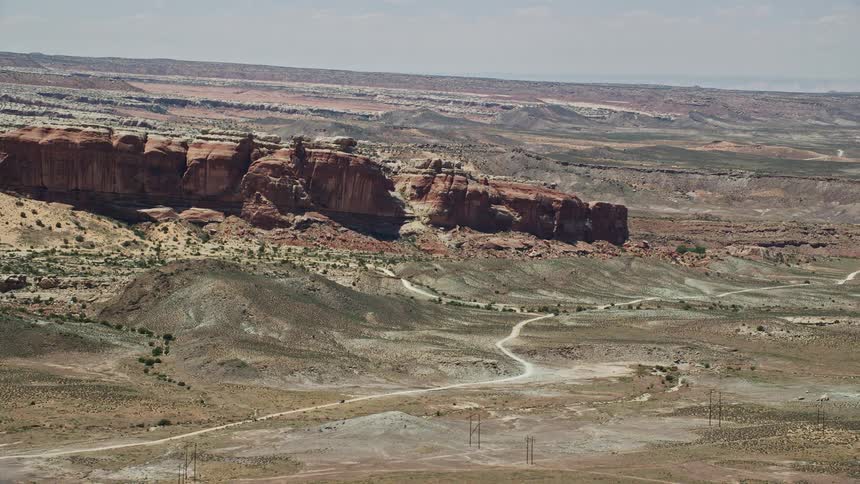 Aerial footage of Cotter Mine Road and desert rock formations in Moab Utah capturing the scenic landscape of the southwest United States