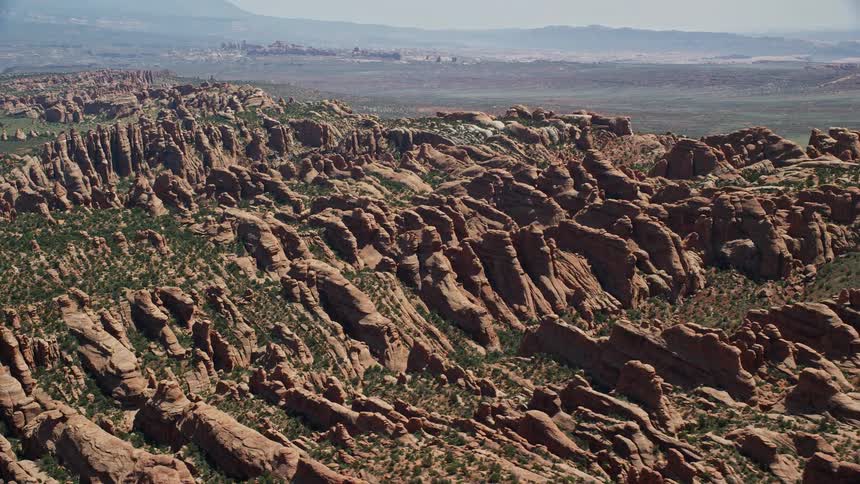 Daytime aerial footage of flying over the iconic Devil's Garden rock formations in Arches National Park Utah showcasing the stunning desert landscape and famous landmarks