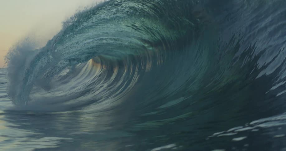 A wave rises up and splashes as it rolls in