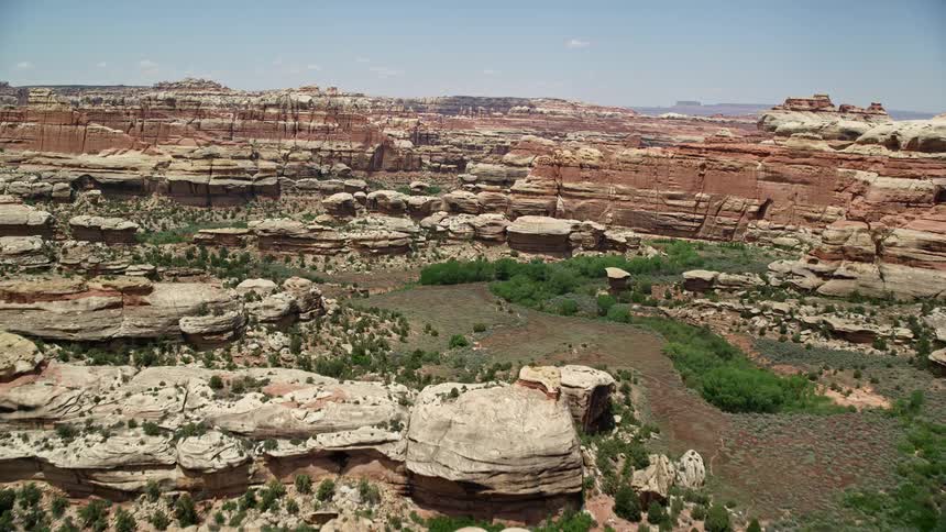  aerial video of flying over and approaching stunning rock formations in Canyonlands National Park Utah showcasing the arid and famous desert landscape