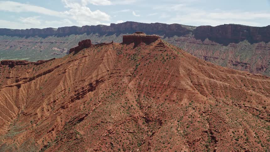 A stunningaerial view of the breathtaking red slopes of desert mountains in Moab Utah captured during a sunny summer day
