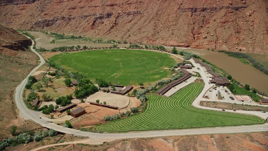 Aerial footage inresolution showcasing an orbit around Red Cliffs Lodge hotel in Moab Utah during a sunny day in summer