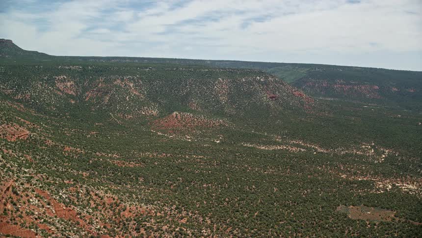Aerial footage of approaching a mesa from nearby mesa cliffs showcasing the stunning landscape of the Manti-La Sal National Forest in Utah