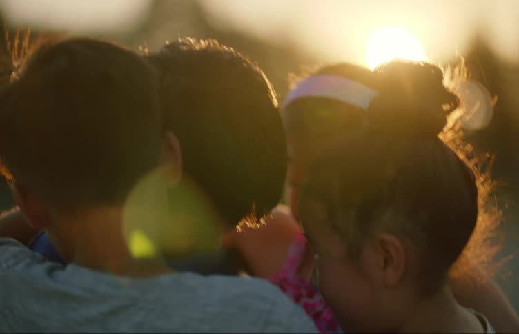 Four children hugging each other emotionally