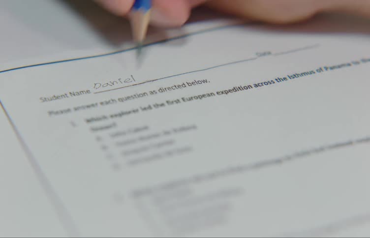 Student fills in their name on answer sheet