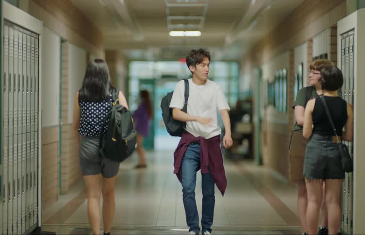 Students greet each other in school hallway