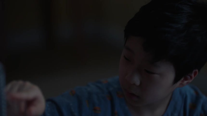 Asian boy turns to look at someone
