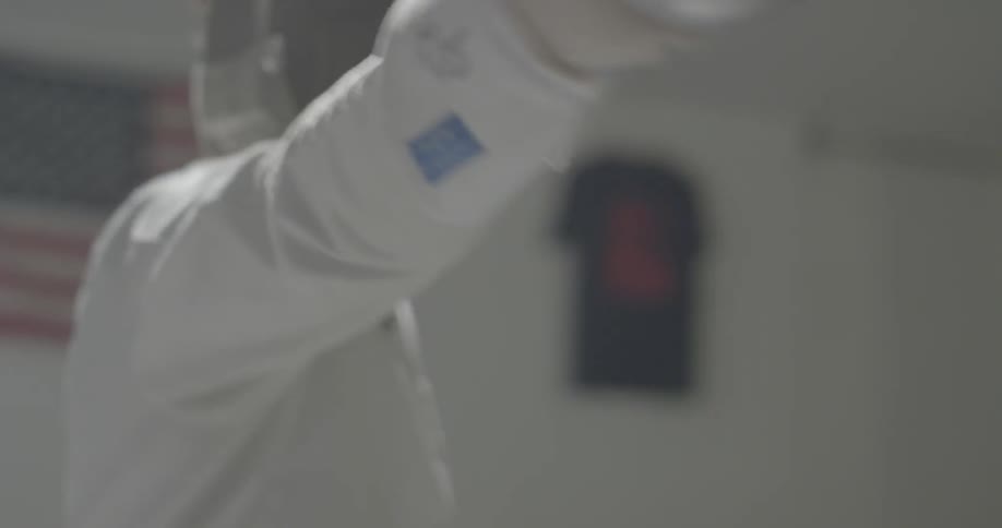 A fencer practices indoors