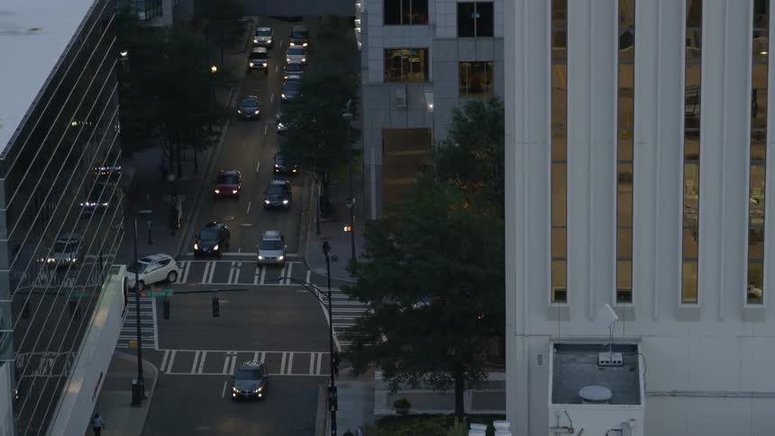 Cars travel down a city street below