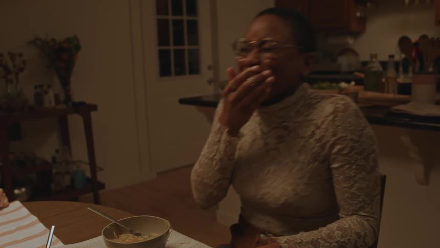 Friends having dinner at home laughing