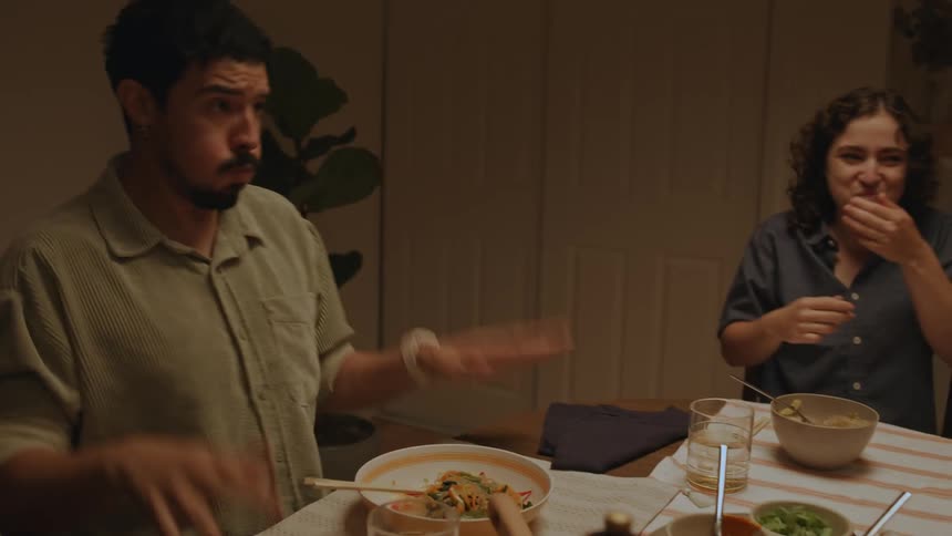 Friends make faces while having dinner