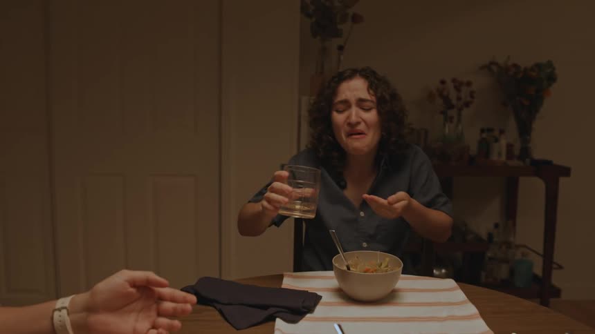 Friends laughing at a dinner table