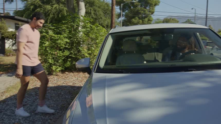 Man tries to enter a car while his friends pranks him