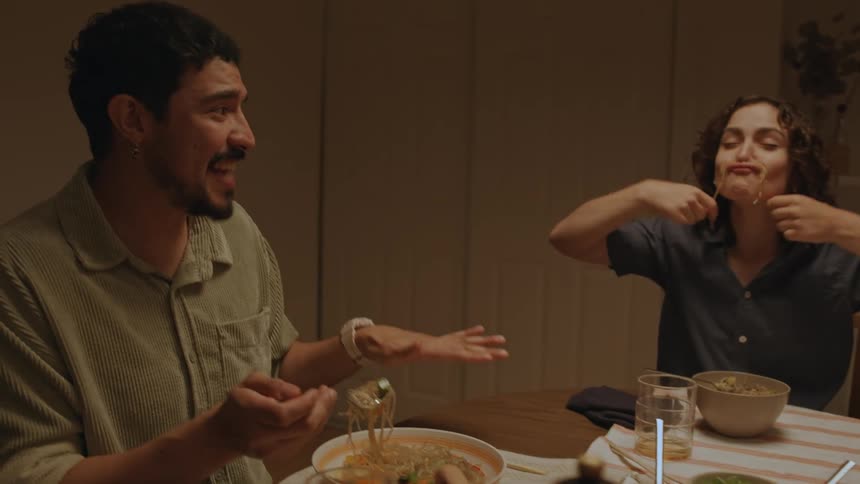 Friends are having dinner and having fun making funny faces