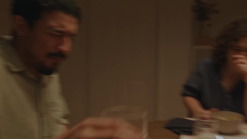 Three friends sitting at a table eating drinking talking and smiling a lot