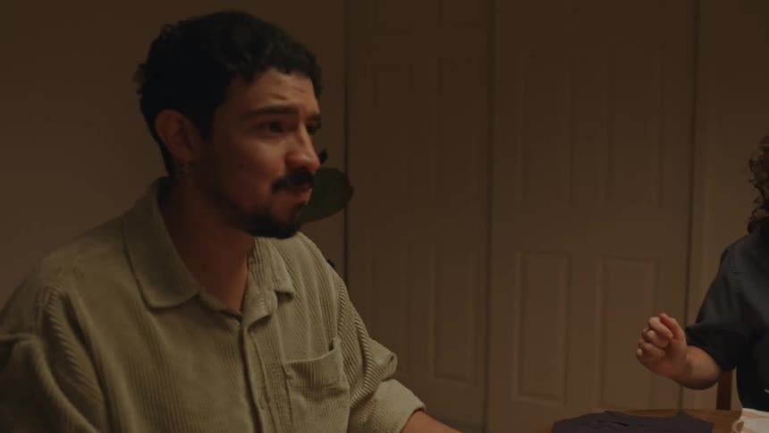 A man and two ladis sitting and eating on the dining table while having fun and laughing