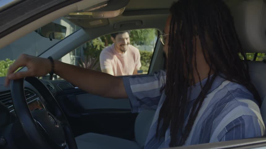 A friend gets in the car and they drive off