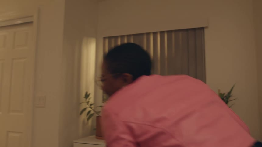 Woman helps a friend to fit a stretch jean in the bedroom