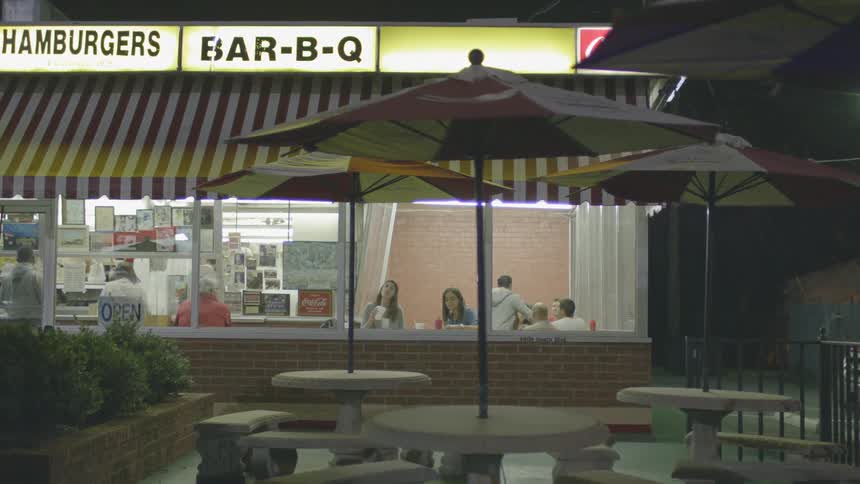 People are eating in a diner at night