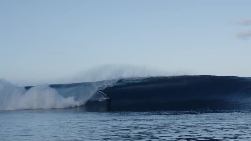 View of a surfer riding a tubular wave
