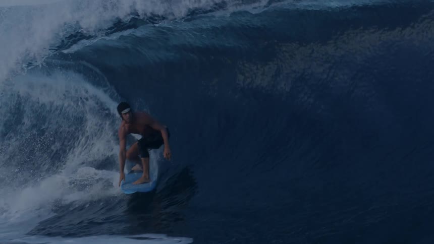A man surfing a tubular wave