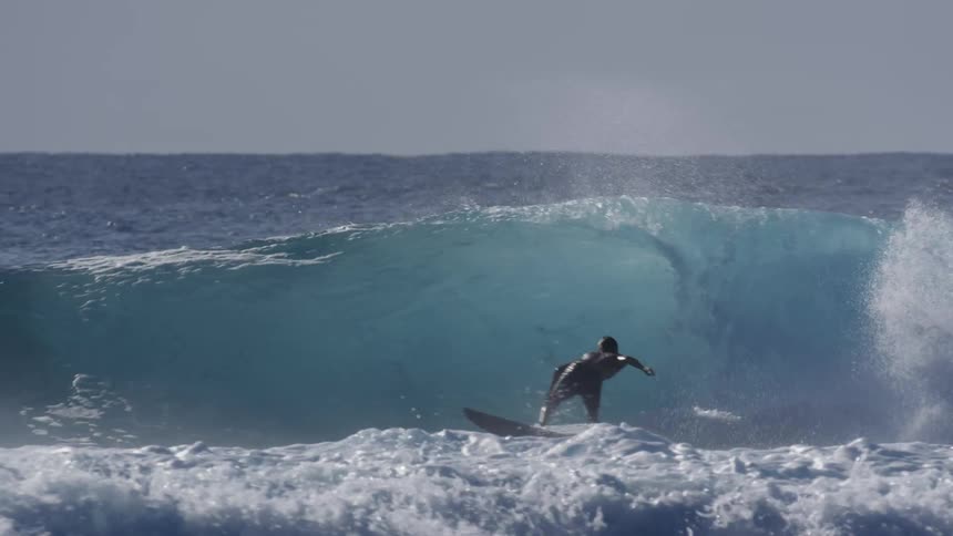 A surfer riding the waves in the sea