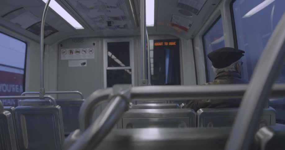 Elderly man riding a subway