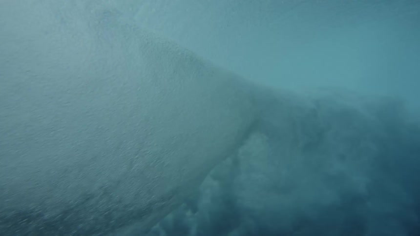 View from inside the sea of a wave forming with strength and foam