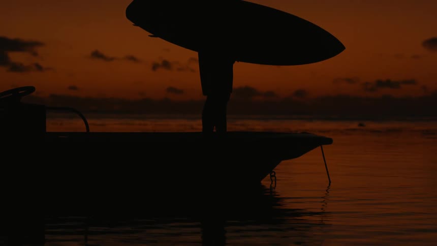 Man standing on the pier watching the sun go down