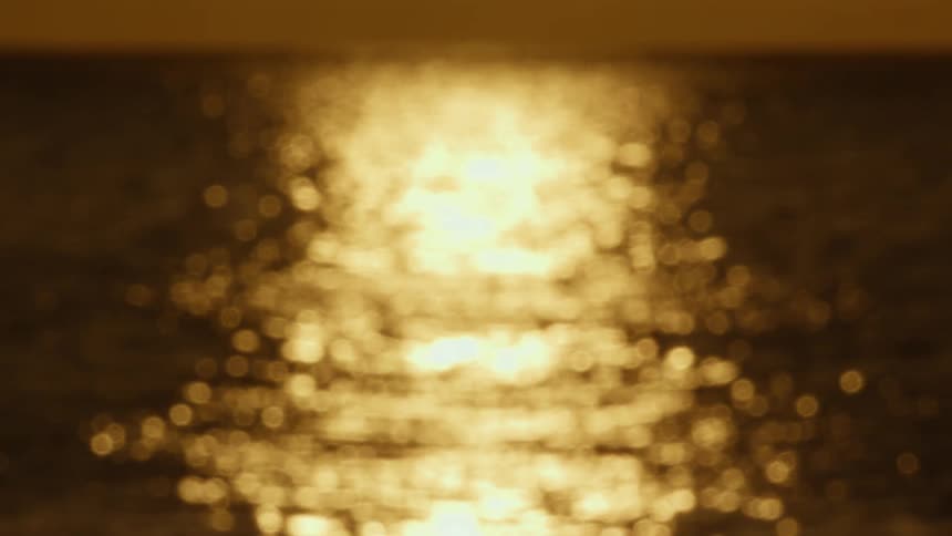 Blurry close up of a water body at sunset
