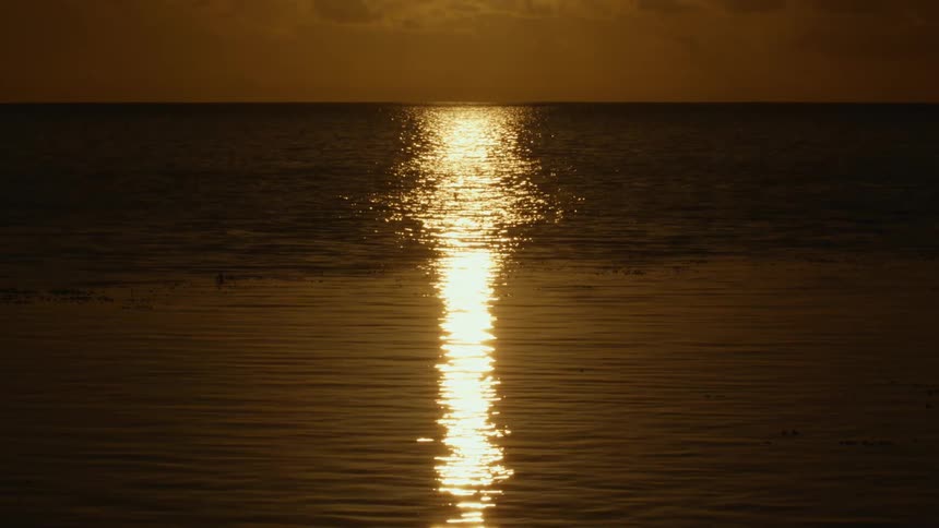 Landscape of sunset reflections on the sea with small ripples