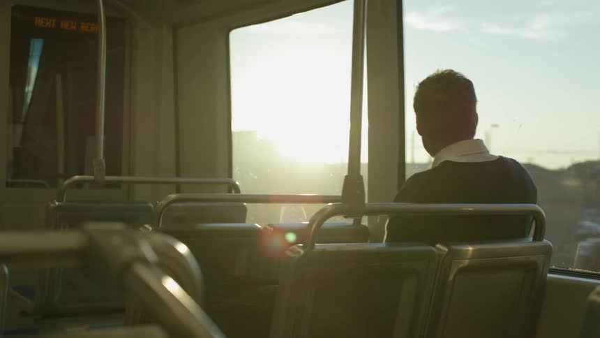 Person riding a train  at sunset