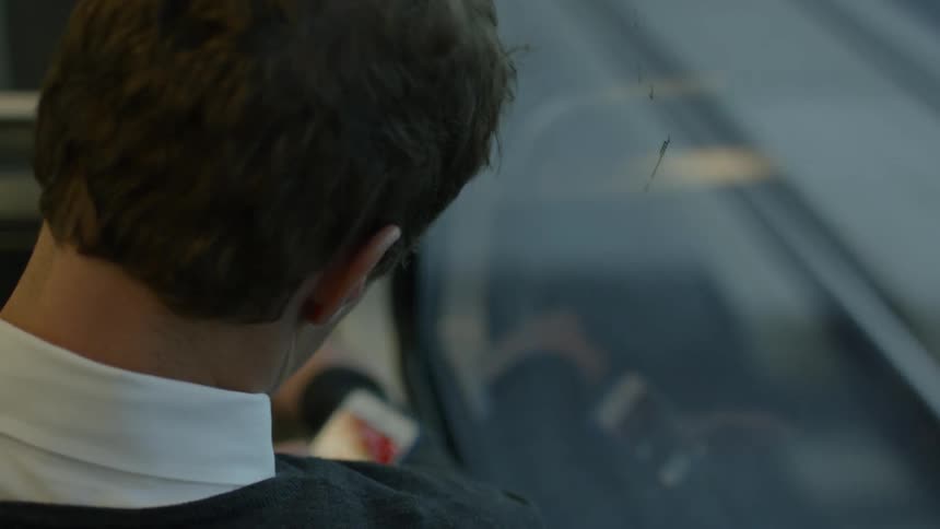 Person using their smartphone while riding a train