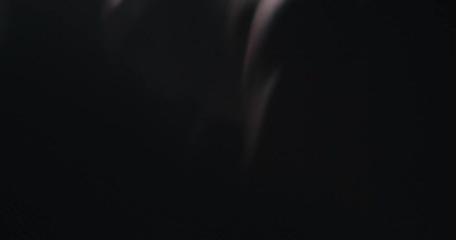 Closeup of a man working out in a dark environment