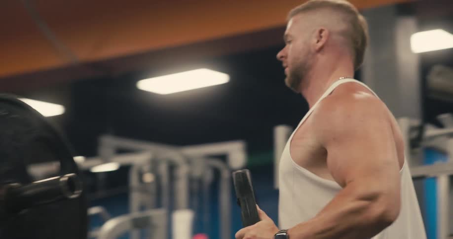 Man placing weight plates on a gym machine