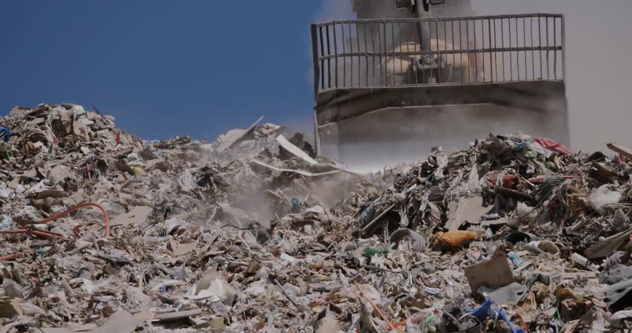 Bulldozer moves trash in landfill