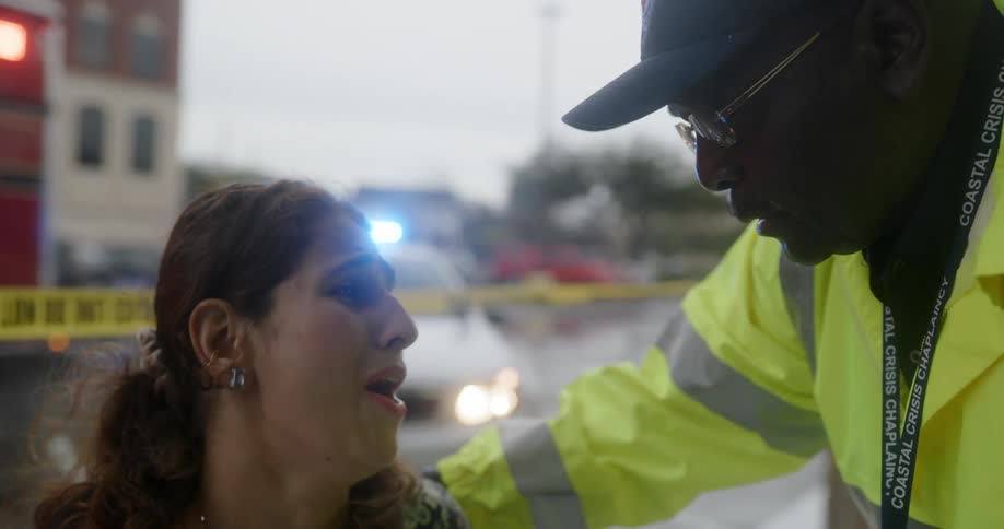 A fireman is consoling a woman who is crying