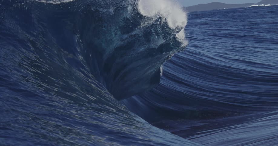 Tall ocean waves crashing into the water creating large splashes