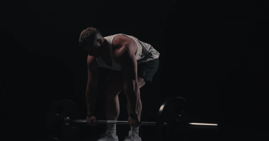 Blonde man performing a barbell lift