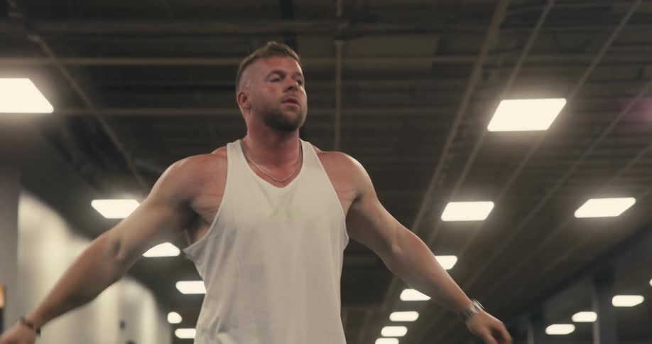Man indoors stretching his arms